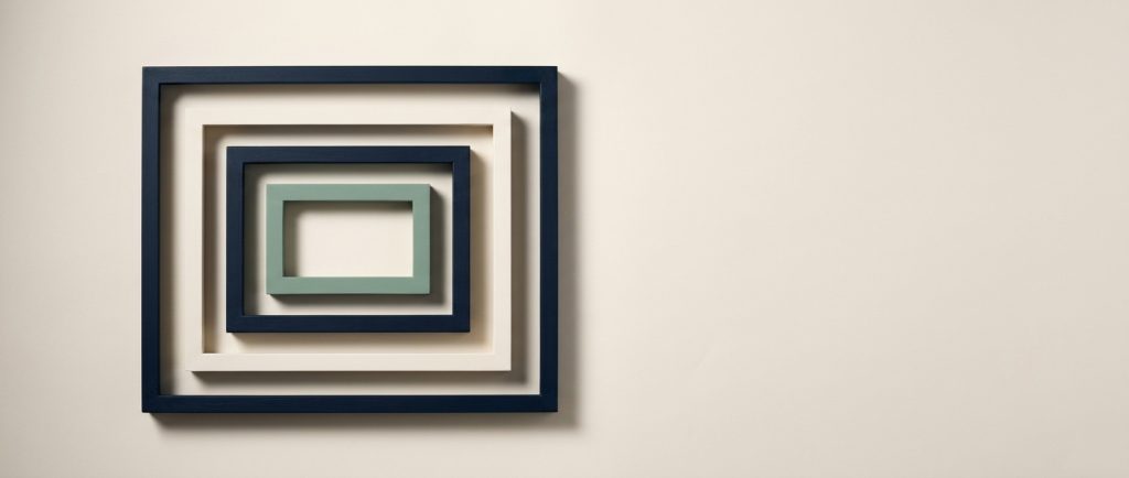 Business knowledge held in one place and used by every tool Four rectangular frames nested one inside another with the innermost in sage, representing layers of understanding.
