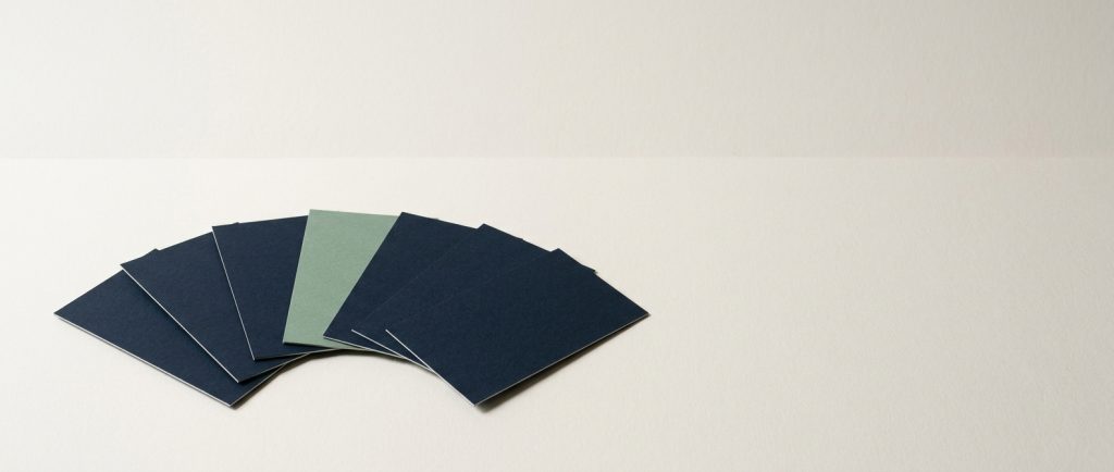 Customer questions answered around the clock Seven cards fanned in an even arc with one in sage, representing every customer receiving the same invitation.