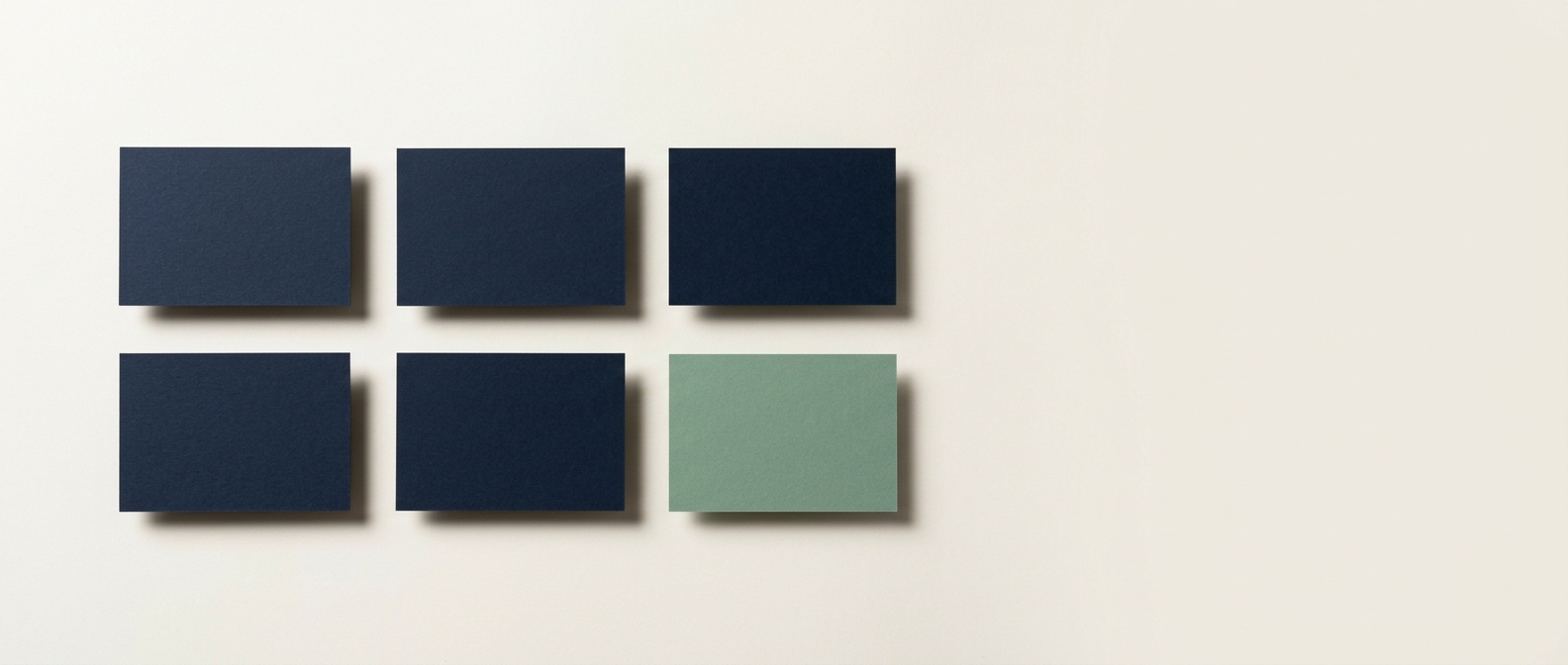 Six plain cards laid flat in two rows of three, five navy and one sage, representing the DNS records behind a domain.